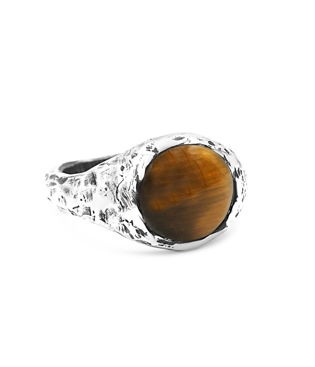 Ring with a brown gemstone and textured silver band on a white background
