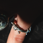 silver barbed wire ring on finger
