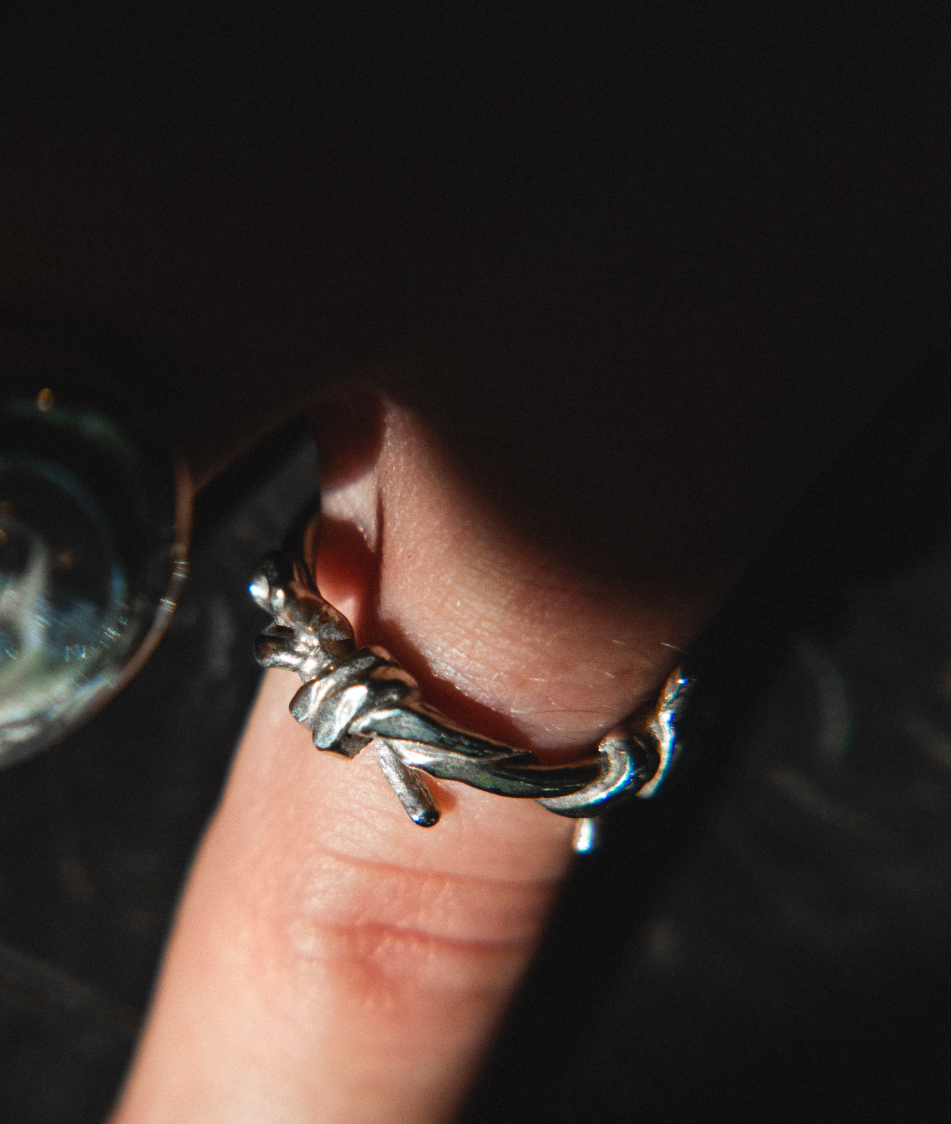 silver barbed wire ring on finger