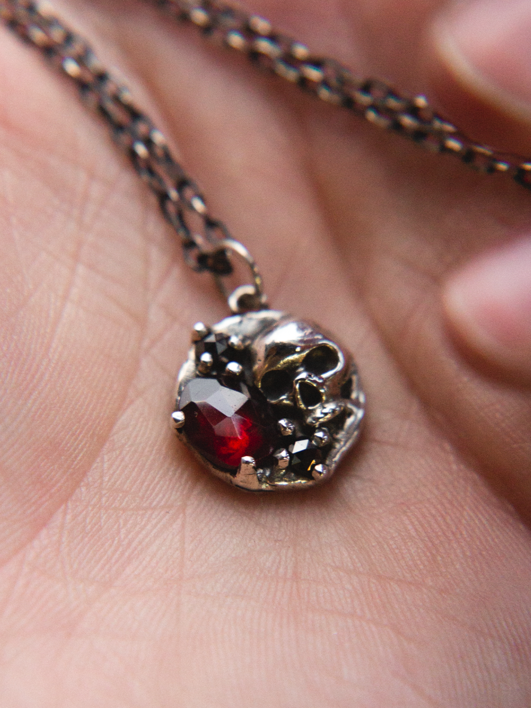 skull necklace in hand