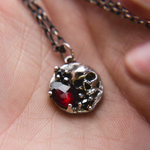 skull necklace in hand