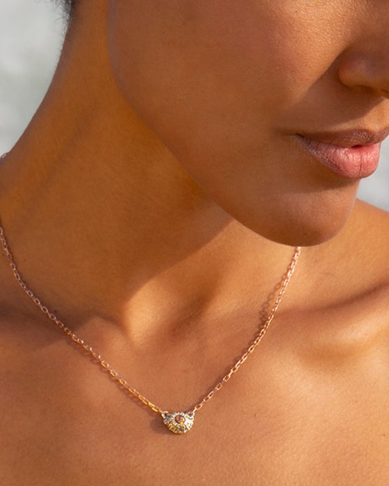 Woman wearing a necklace and earring with a blurred background