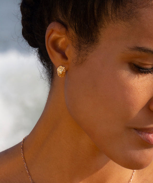Woman wearing a necklace and earring with a blurred background