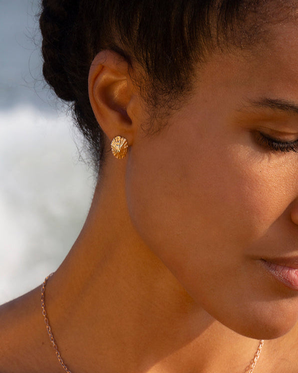 Woman wearing a necklace and earring with a blurred background