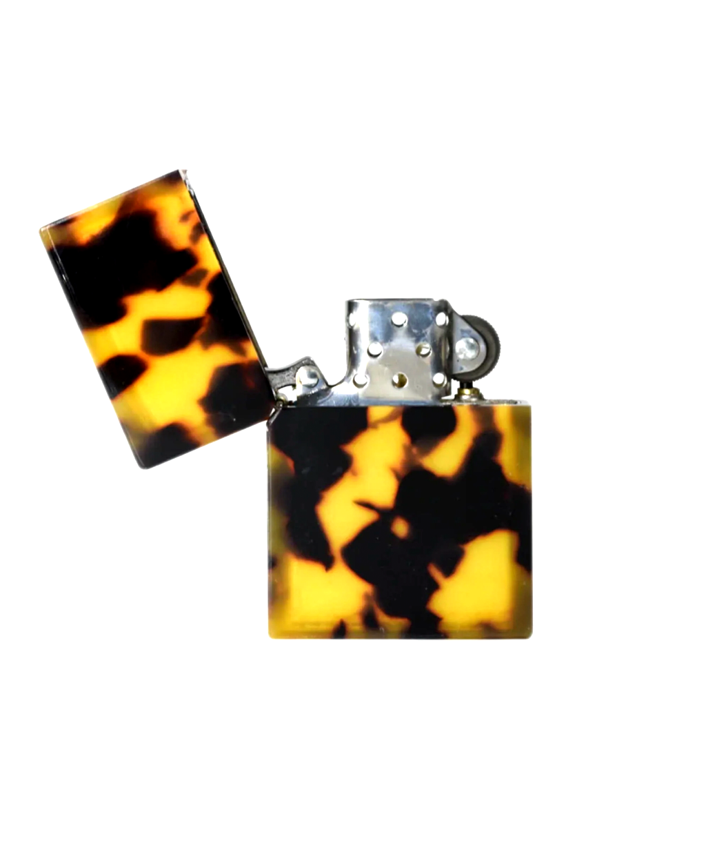 Tortoiseshell patterned lighter on a white background