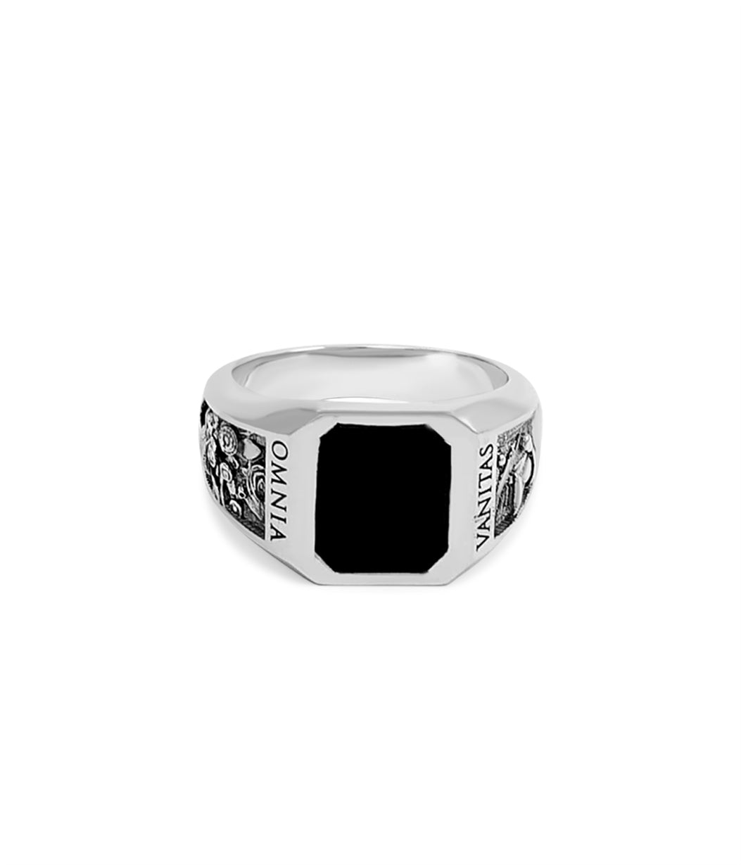 Silver ring with black stone on a white background