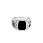 Silver ring with black stone on a white background