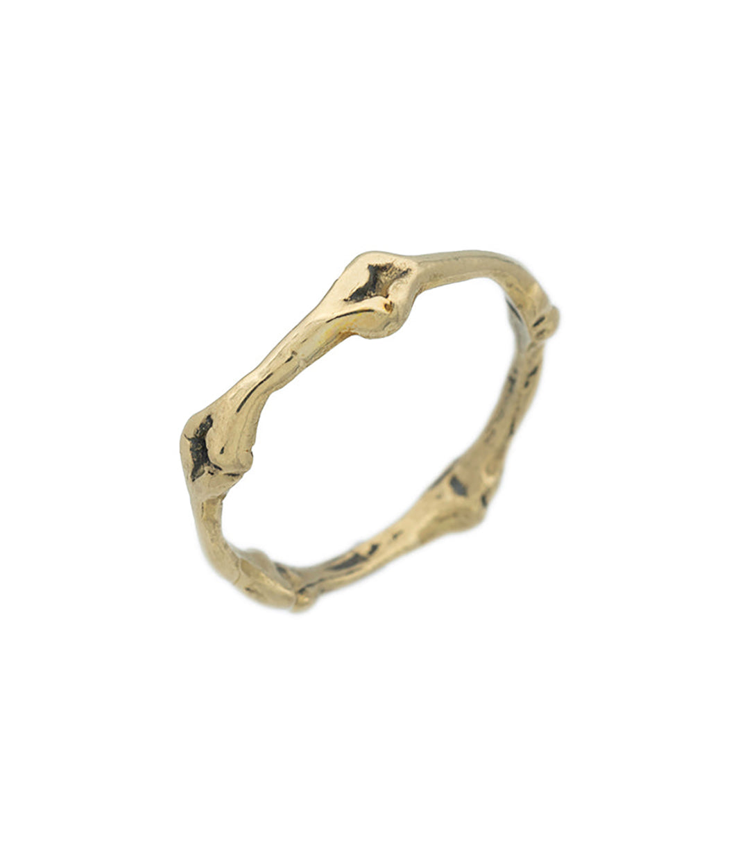 Gold ring with a unique design on a white background
