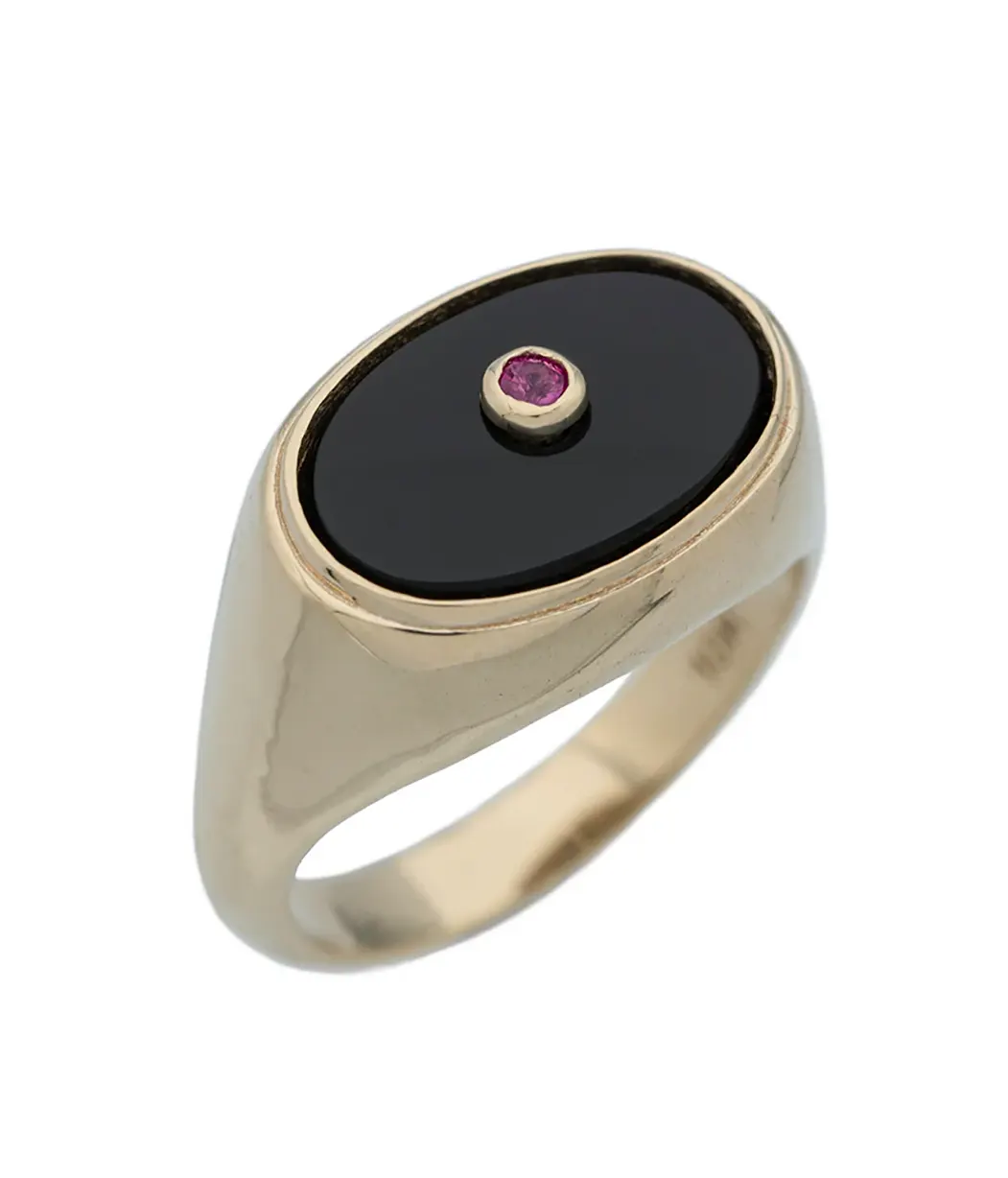 Gold ring with a black stone and red gemstone on a white background