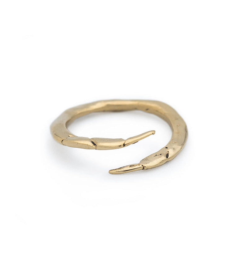 Gold ring with a unique design on a white background